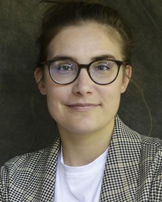 Headshot of Barbara Wolfram in front of a green background