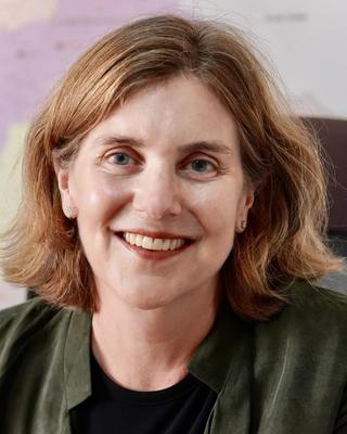 Headshot of Karin Heissler situated against a blurred background