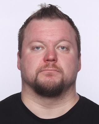 Headshot of Jarmo Kallunki in front of a light purple background