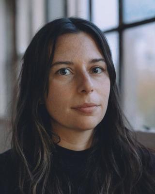Headshot of Laura Tanguay in front of a window