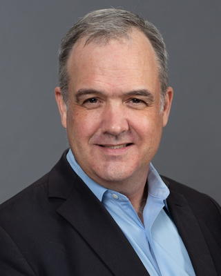 Headshot of Daniel Carpenter in front of a dark grey background