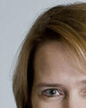 Headshot of Anne Becker against a grey backdrop