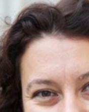 Headshot of Gokce Yurdakul set against a blurred background