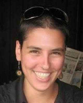 Headshot of Yael Rimer-Cohen set against a blurred background
