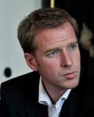 matthias_koenig_sitting_serious_face