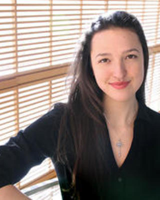 nina_gheihman_standing_on_wcfia_stairs_smiling