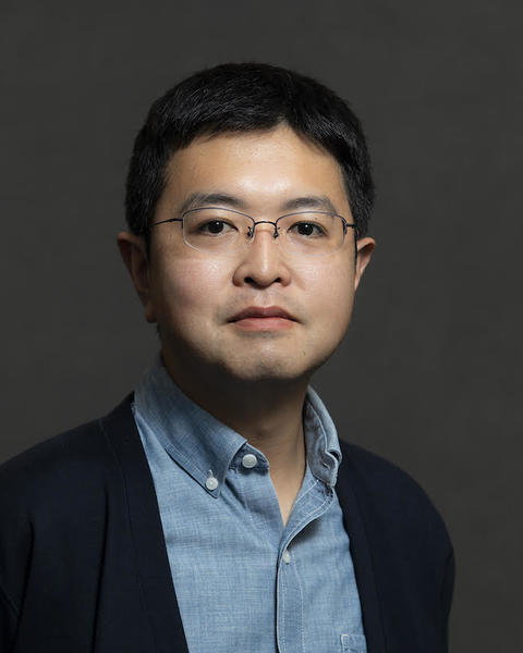 Headshot of Fumiya Uchikoshi in front of a grey background