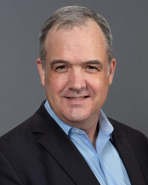 Headshot of Daniel Carpenter in front of a dark grey background
