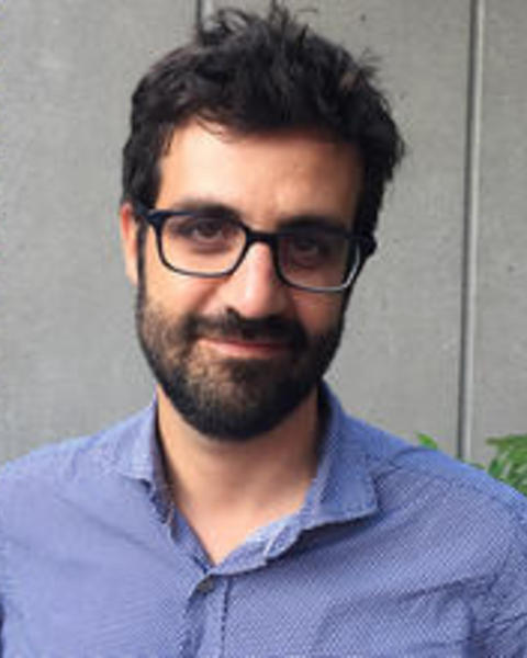 Headshot of Bruno Carvalho in front of a grey background 
