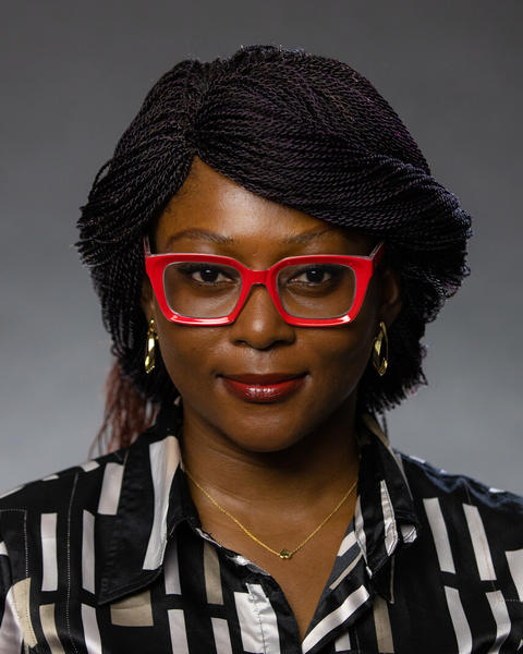 Headshot of Gbemisola Abiola in front of a grey background