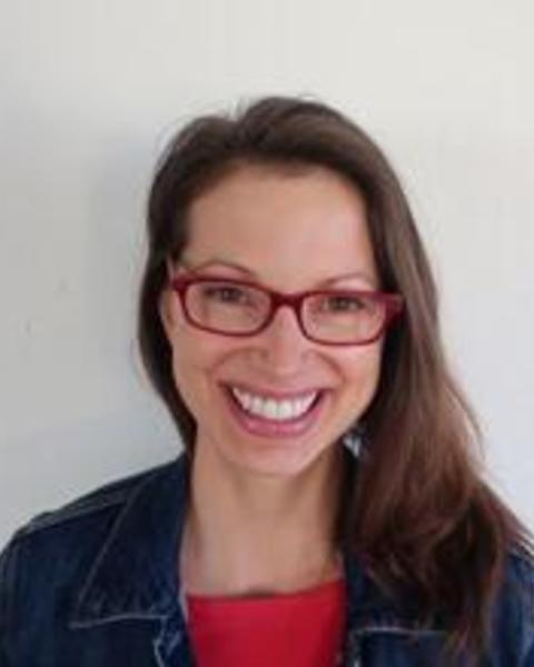 Headshot of Caitlin Daniel in front of a grey background