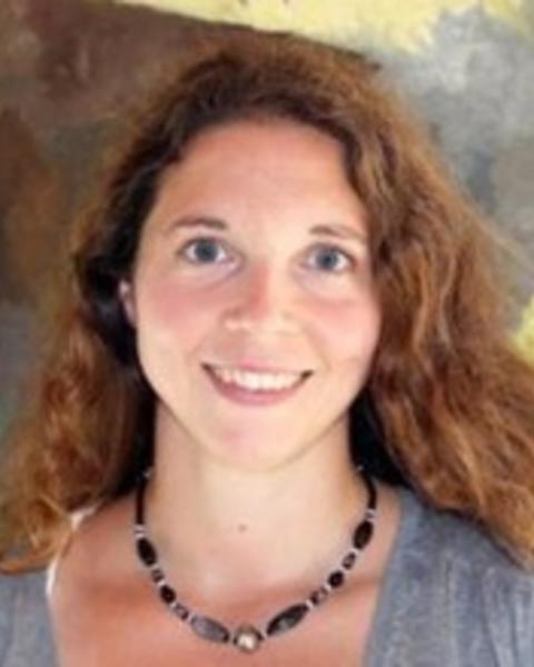 Headshot of Camille Hamidi standing inside smiling