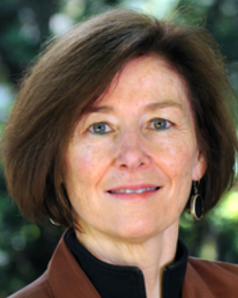 Headshot of Diane Davis standing outside against trees