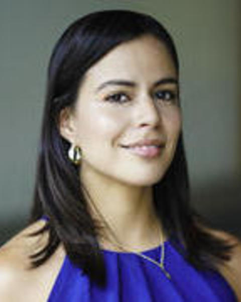 Headshot of Mari Sanchez in front of a blurred background