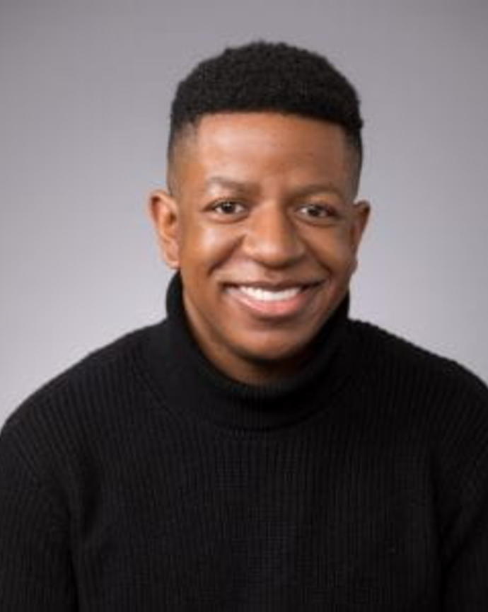 Headshot of Clayton Covington in front of a grey background