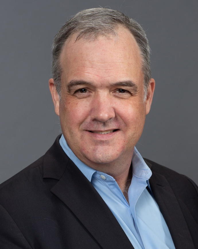 Headshot of Daniel Carpenter in front of a dark grey background