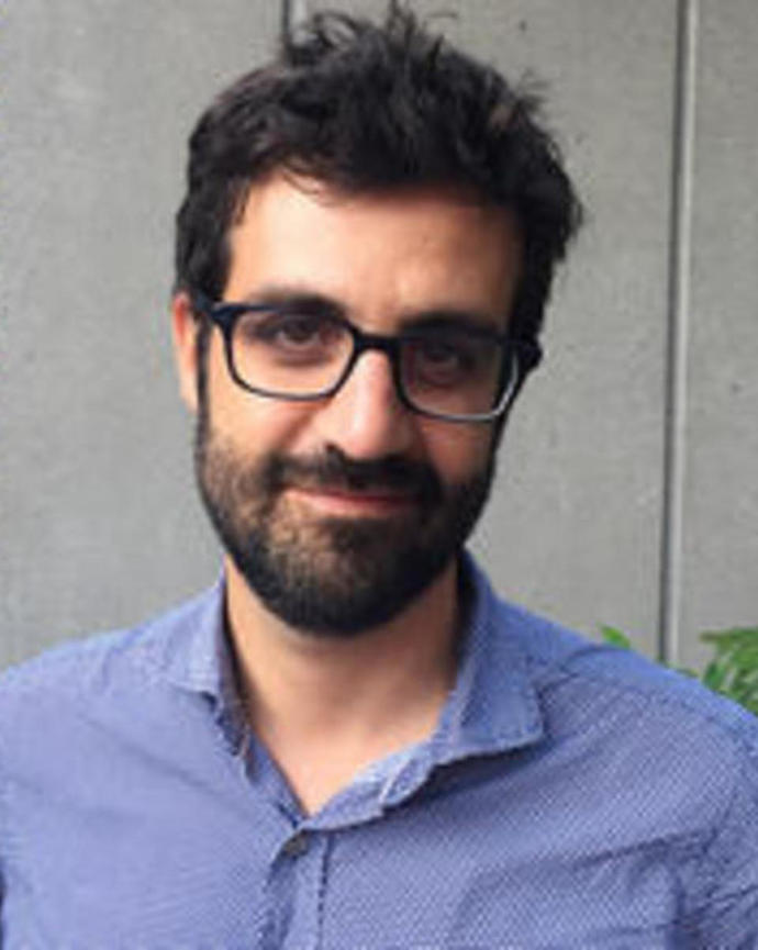 Headshot of Bruno Carvalho in front of a grey background 