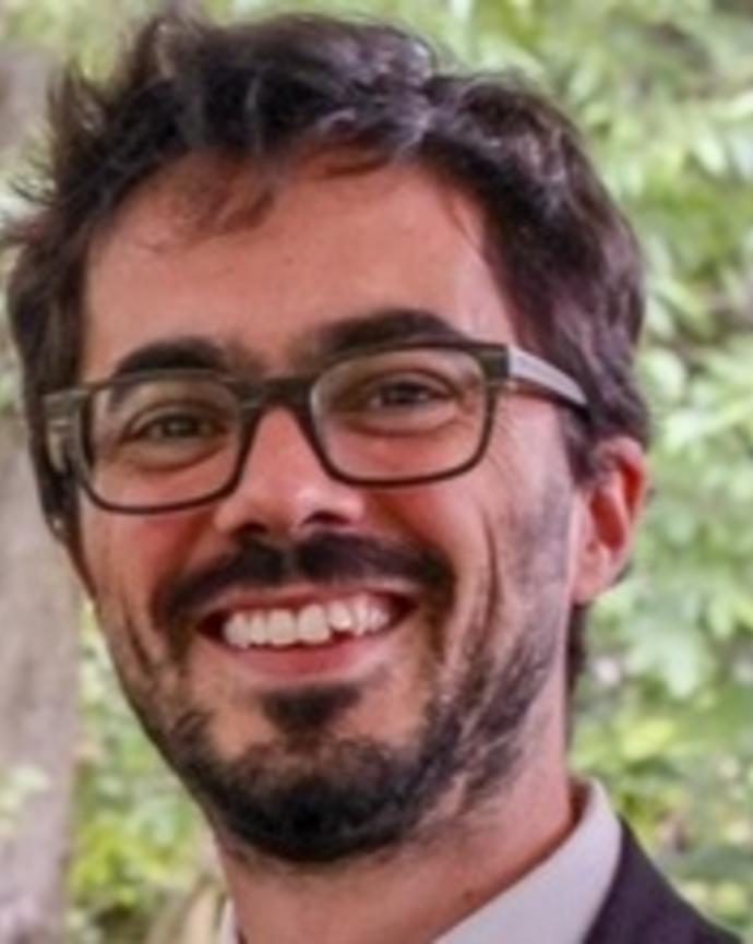 Headshot of Adrien Abecassis standing in front of a tree
