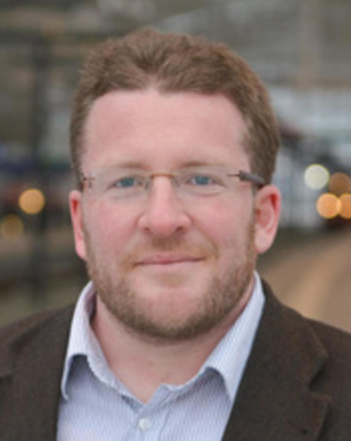 Headshot of Wolfgang Aschauer at a train station