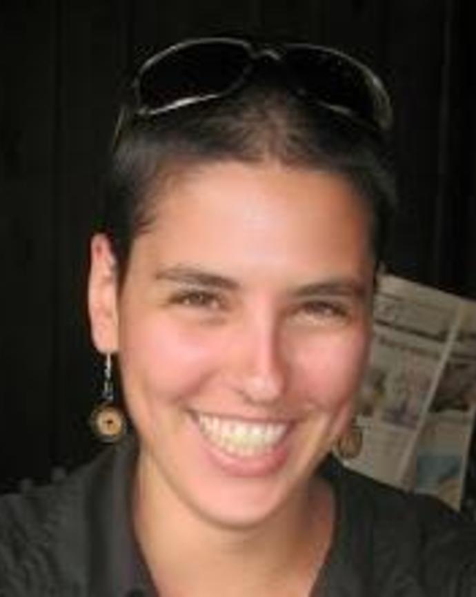 Headshot of Yael Rimer-Cohen set against a blurred background