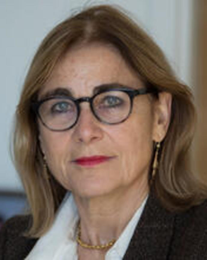 Headshot of Jacqueline Bhabha in front of a blurred background